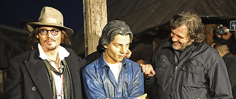 Johnny Depp, Kusturica y una talla que representa al actor, en Küstendorf. | AFP