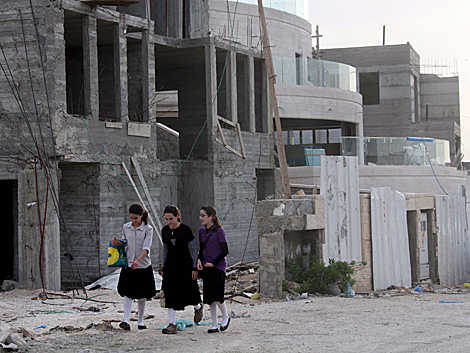 Tres niñas caminan por las calles en construcción del asentamiento  Ramat Shlomo. | Efe