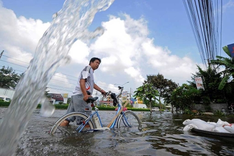 Un hombre, entre el agua en Bangkok.| afp