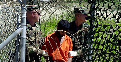 Dos soldados escoltan a un preso en la base de Guantánamo. | E. M.